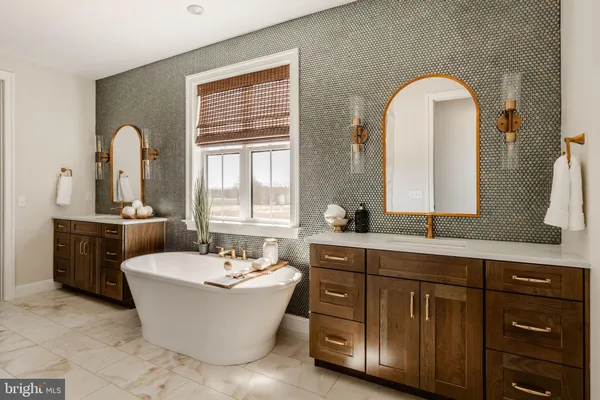a bathroom with a double vanity sink a mirror and a bathtub