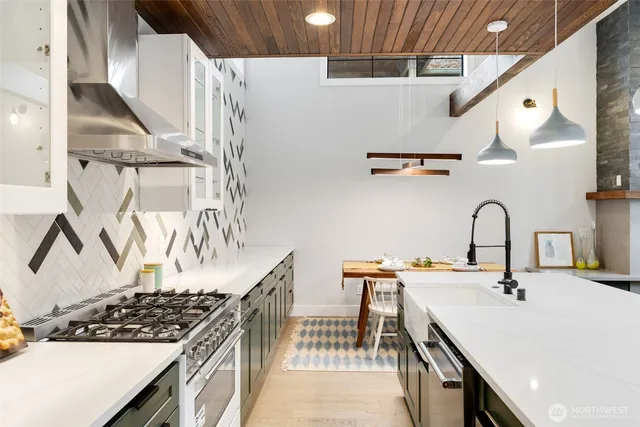 a kitchen with sink stove and cabinets