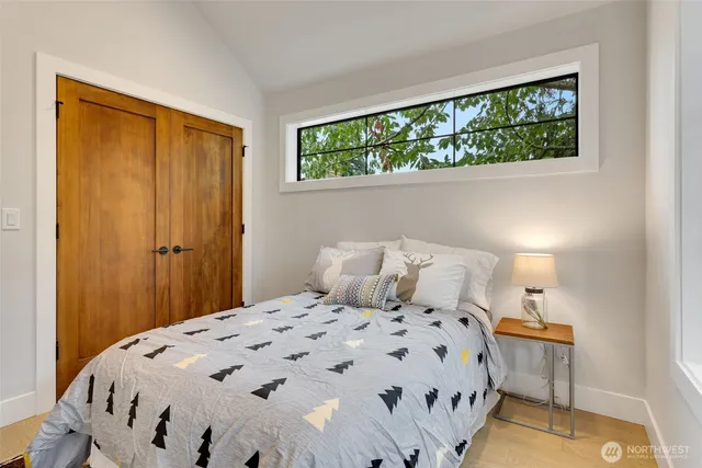 a bedroom with a bed and a window