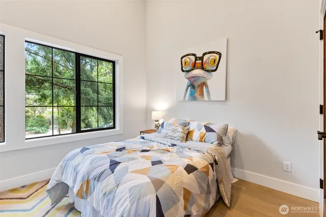 a bedroom with a bed and a painting on the wall