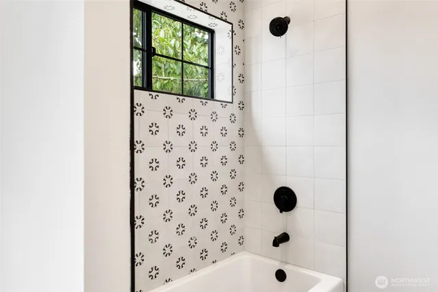 a bathroom with a bathtub and a shower