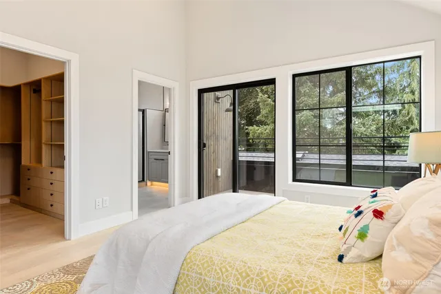 a bedroom with a bed and a large window