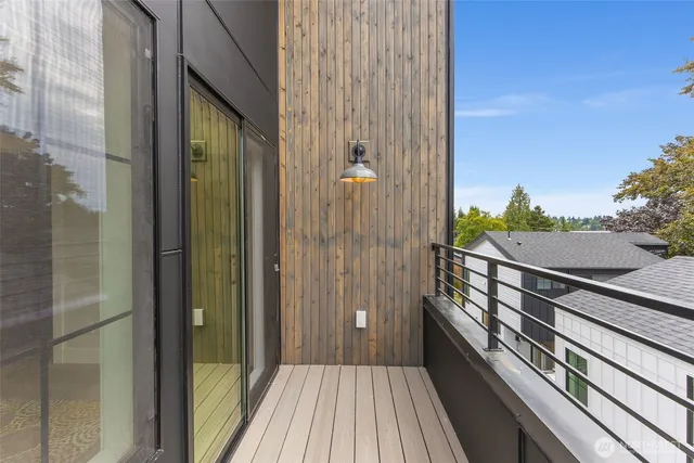 a view of a balcony with wooden floor and fence