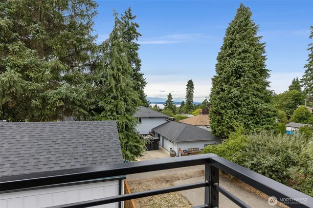 a view of a wooden bench and trees in the background