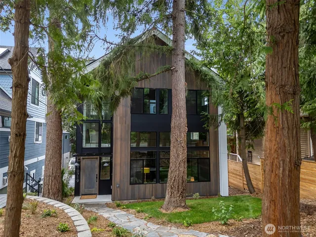 a view of a house with a tree in front of it