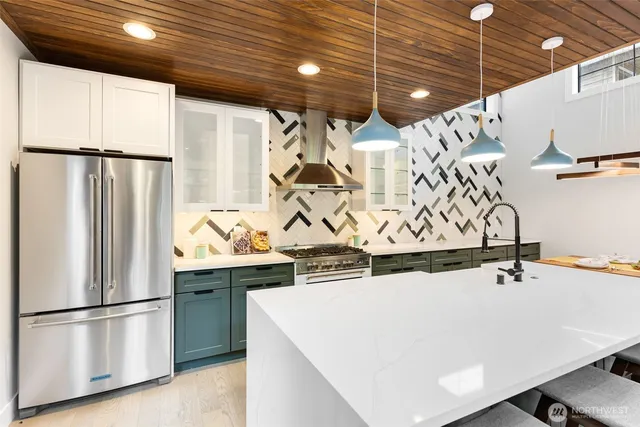 a kitchen with stainless steel appliances a refrigerator and a sink