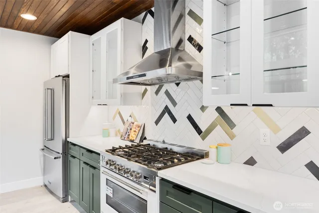a kitchen with stainless steel appliances granite countertop a sink and a stove
