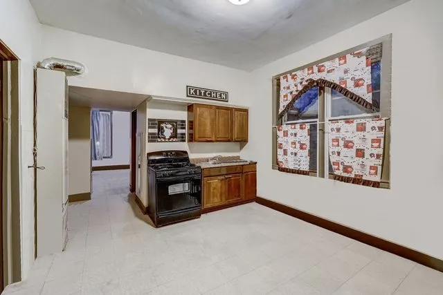 a kitchen with stainless steel appliances a refrigerator and a stove top oven