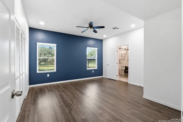 wooden floor in an empty room with a window