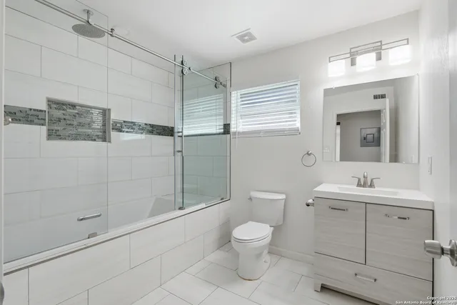 a bathroom with a toilet sink and shower