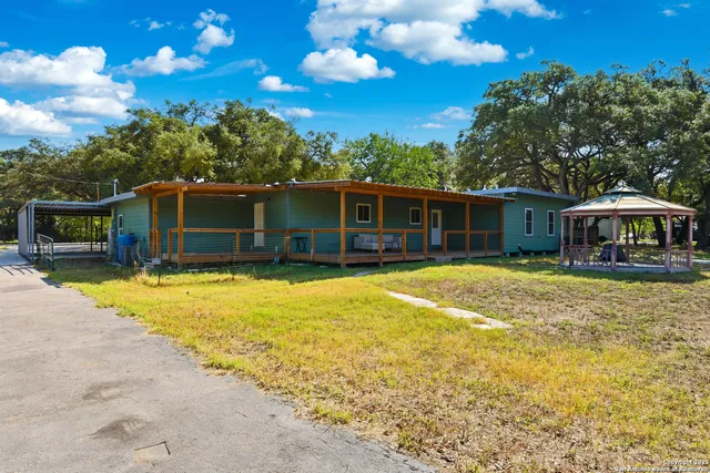 a front view of house with a garden
