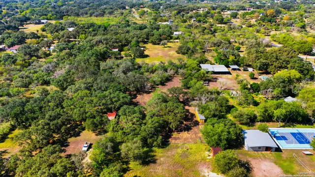 an aerial view of residential houses with yard