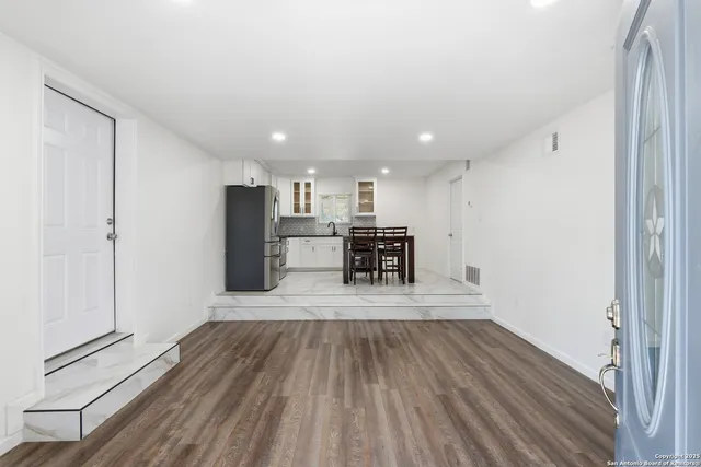 a view of kitchen view wooden floor and electronic appliances