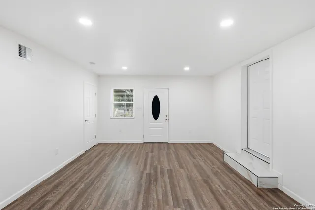 a view of room with wooden floor