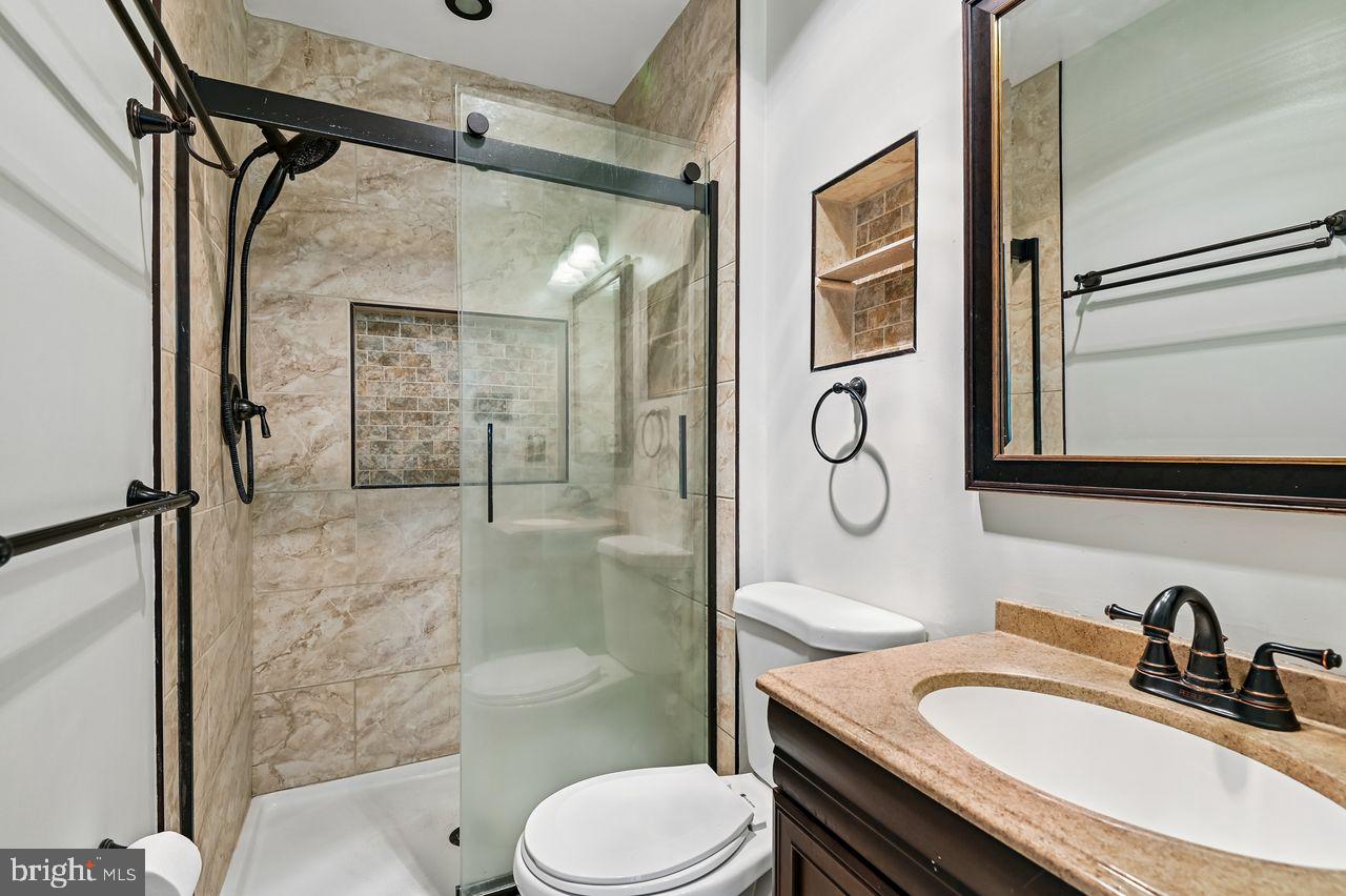 746 Match Point Drive Arnold, MD 21012 - Photo 23 of 52 a bathroom with a granite countertop sink toilet and shower