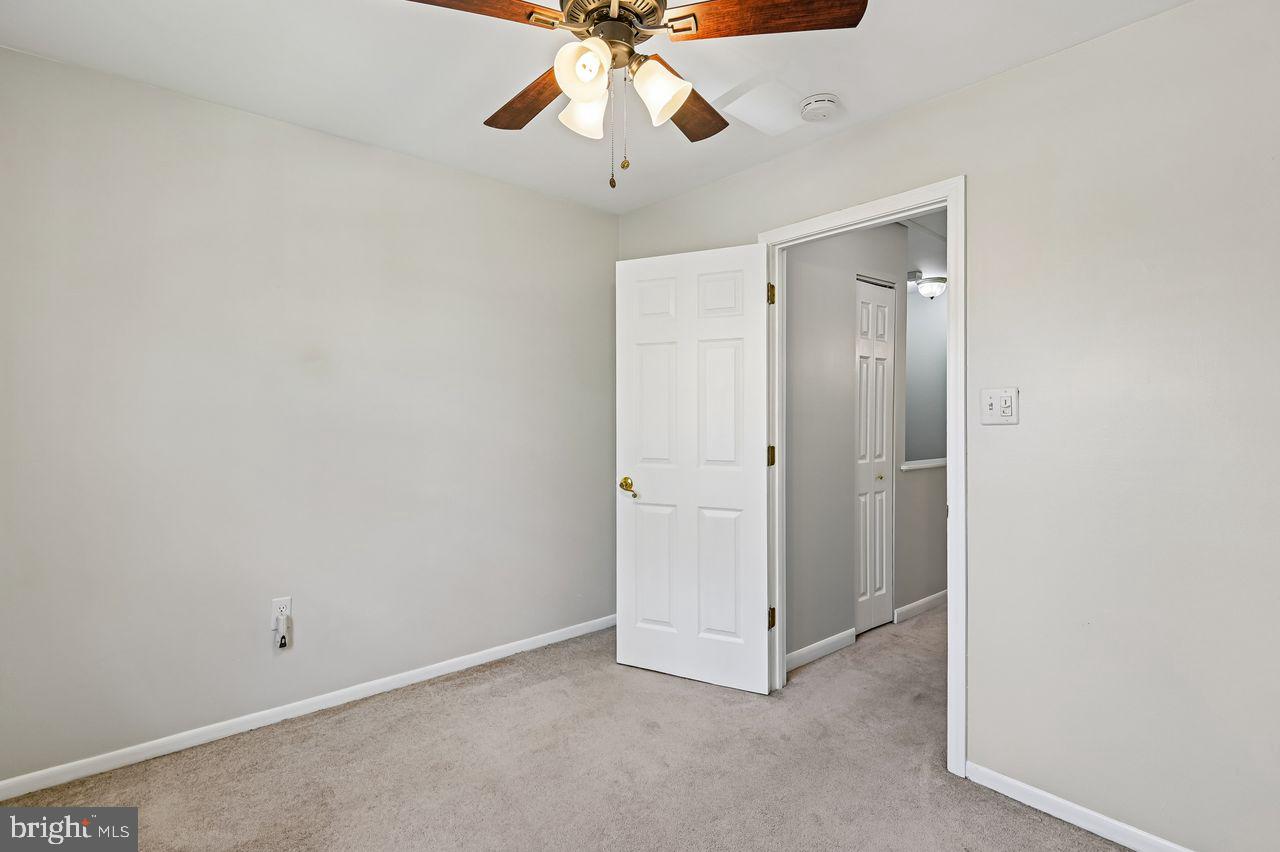 746 Match Point Drive Arnold, MD 21012 - Photo 25 of 52 an empty room with a ceiling fan and carpet
