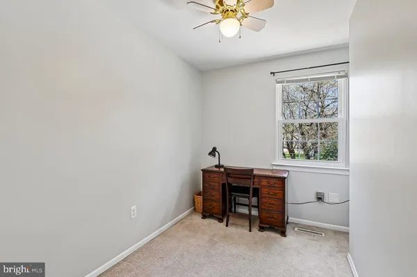 a bathroom with a sink vanity mirror and toilet