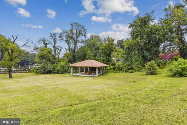 a view of outdoor space with garden and trees