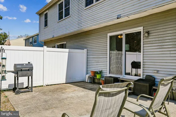 a view of two chairs in the patio