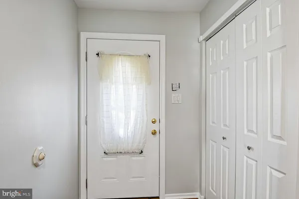 a kitchen with stainless steel appliances granite countertop a stove a refrigerator and white cabinets