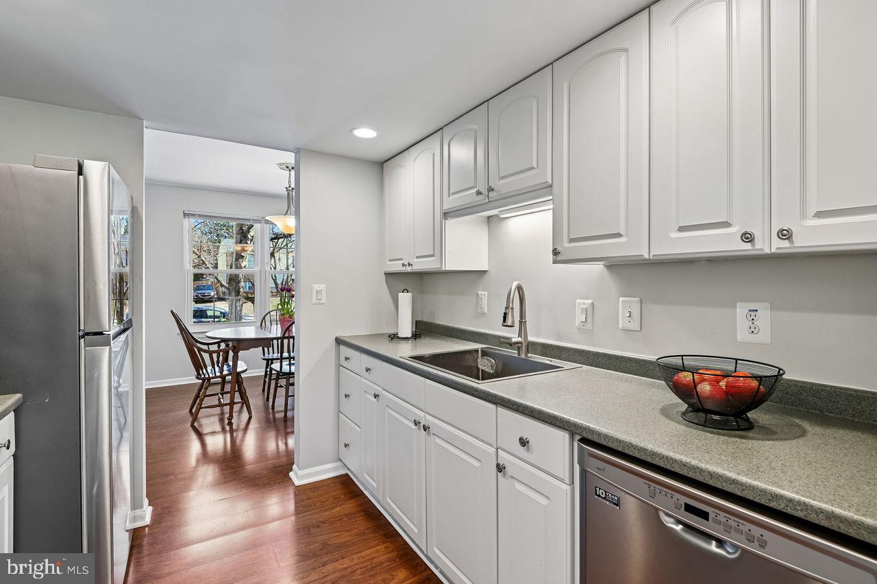 746 Match Point Drive Arnold, MD 21012 - Photo 9 of 52 a kitchen with stainless steel appliances granite countertop a stove a refrigerator and white cabinets