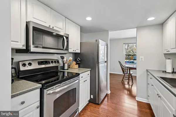 a kitchen with granite countertop a sink and cabinets