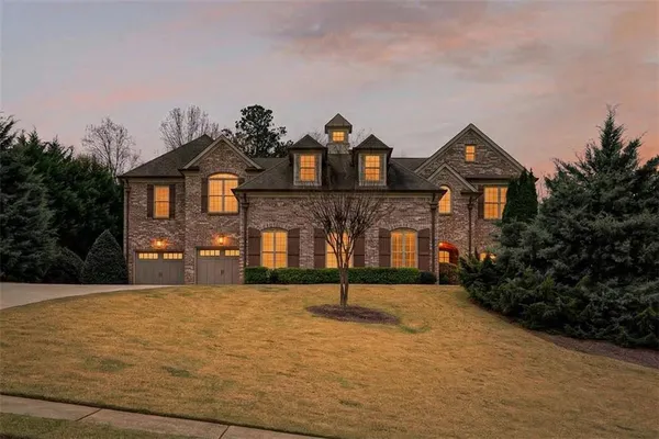a front view of a house with a yard and garage