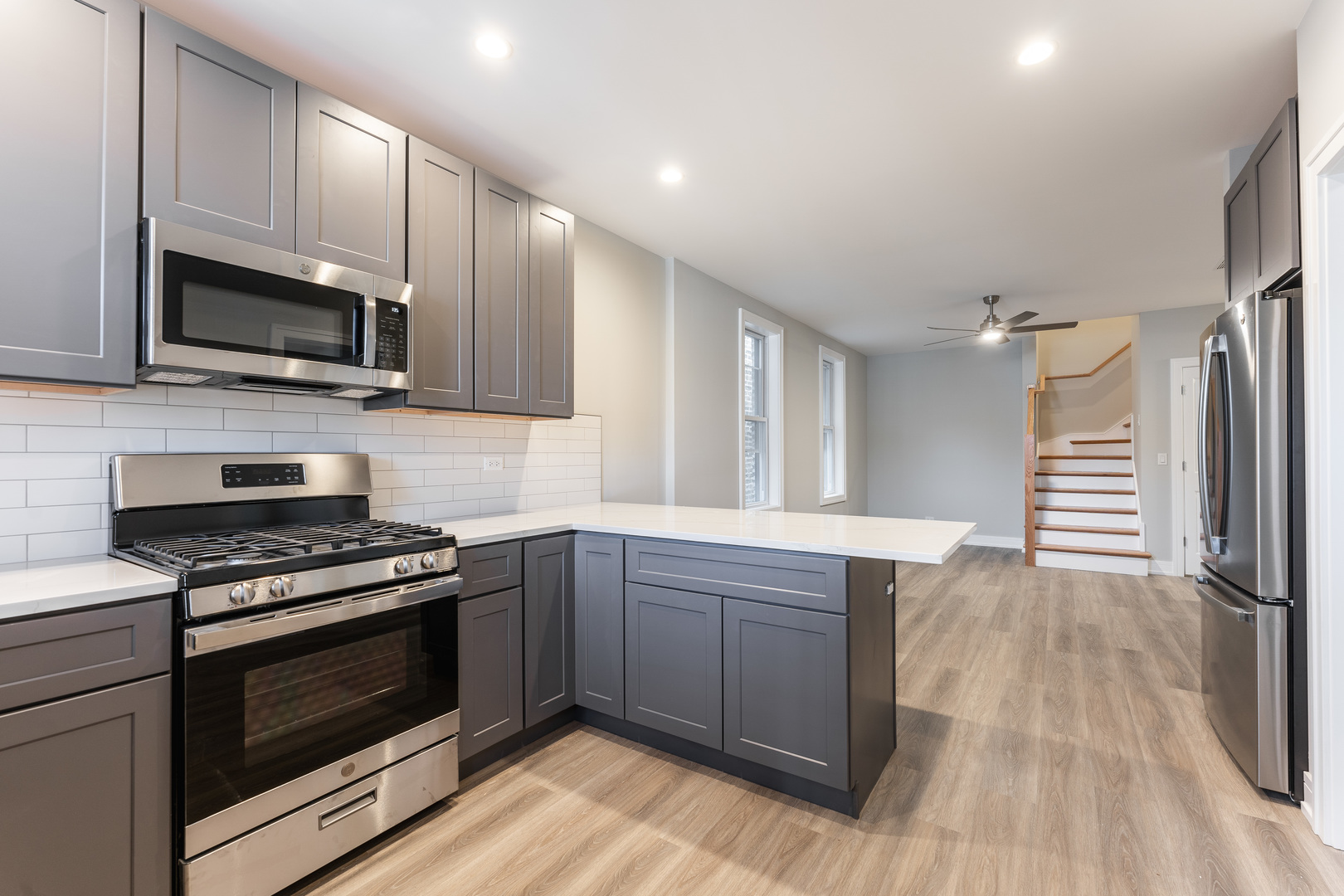 1725 North Honore Street, Unit 2R Chicago, IL 60622 - Photo 4 of 9 a kitchen with stainless steel appliances a stove microwave and sink