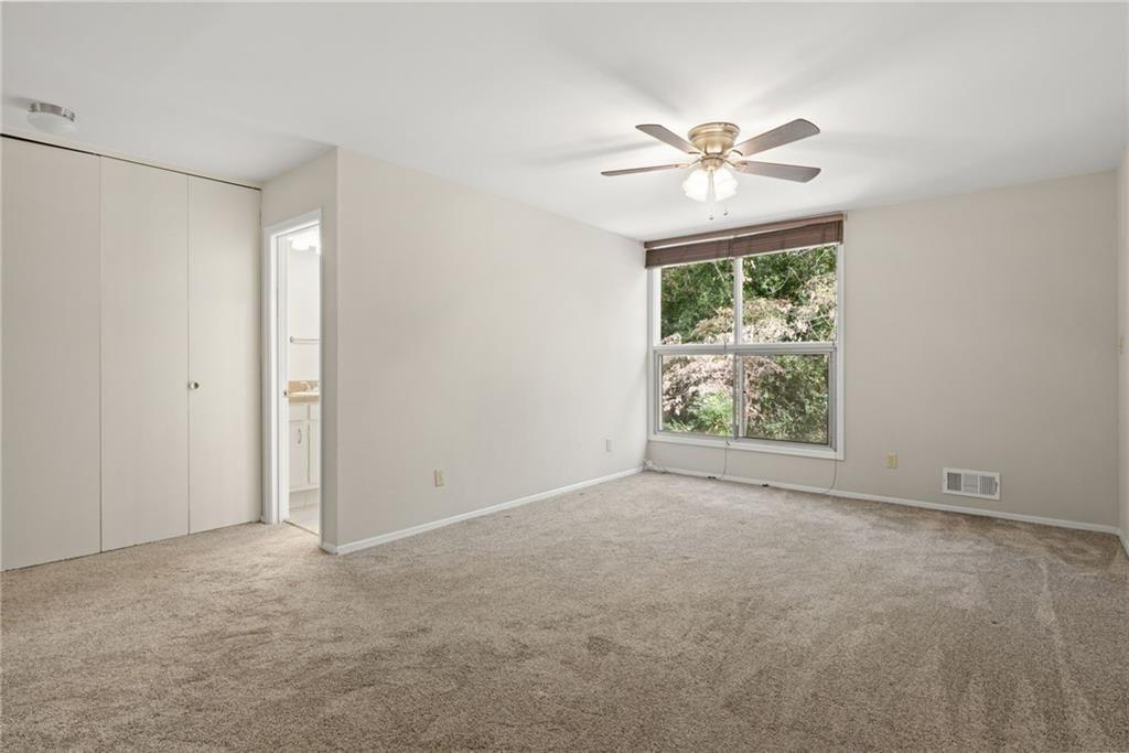 705 Edgewater Trail Sandy Springs, GA 30328 - Photo 23 of 36 a view of an empty room with window and a fan
