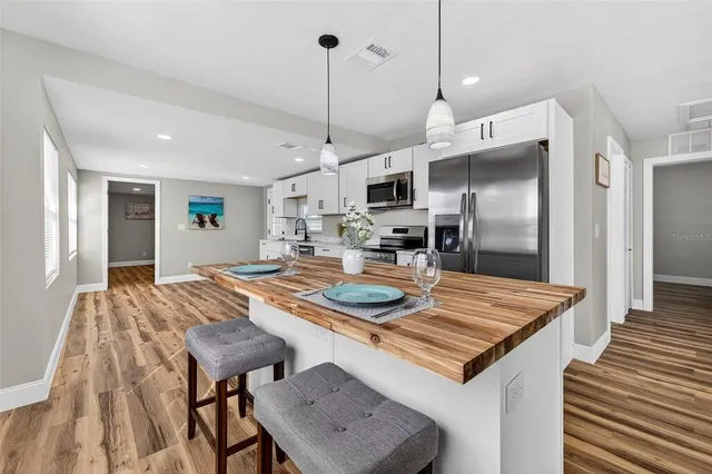 a kitchen with stainless steel appliances a stove microwave and cabinets