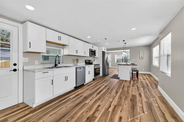 a view of kitchen with sink and wooden floor
