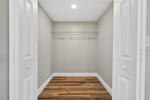 a spacious bathroom with a granite countertop sink a toilet and a shower