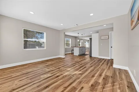a living room with stainless steel appliances kitchen island granite countertop furniture and a kitchen view