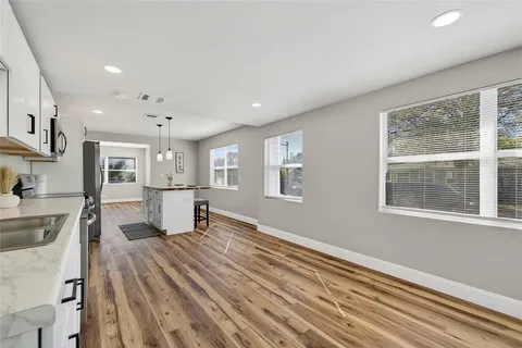 a kitchen with stainless steel appliances granite countertop a stove sink and microwave