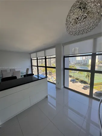a large white kitchen with a large window