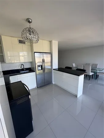 a living room with furniture and chandelier