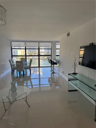 a living room with furniture a flat screen tv and a table