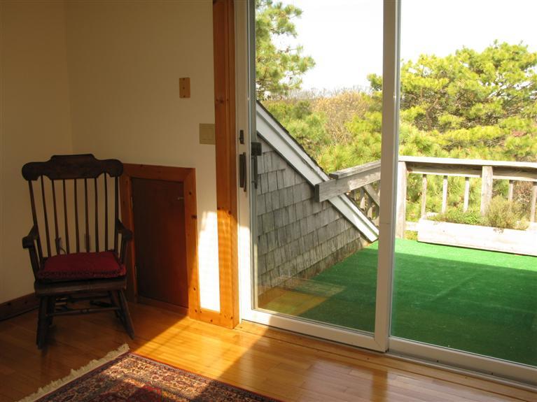 20 Massasoit Road Wellfleet, MA 02667 - Photo 18 of 35 a view of a balcony with floor to ceiling windows with wooden floor