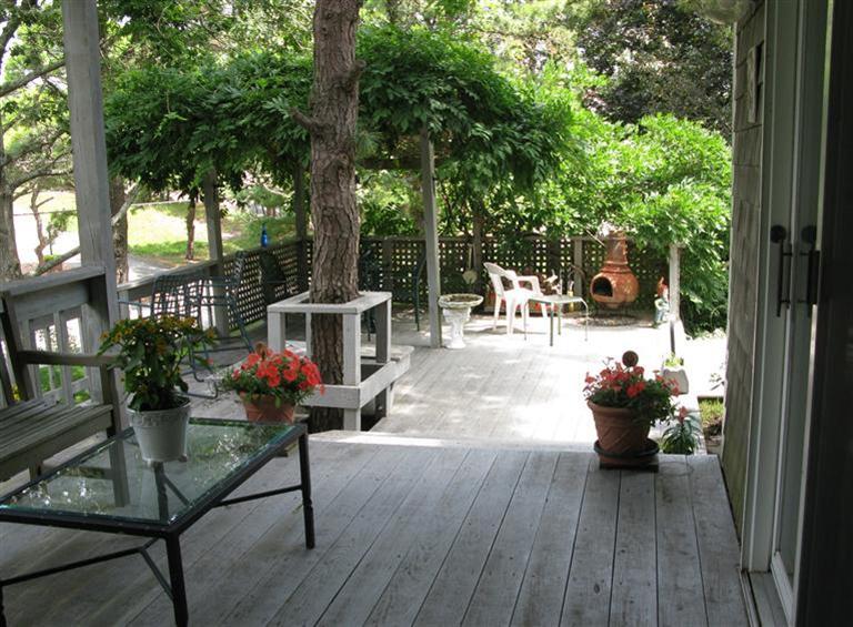 20 Massasoit Road Wellfleet, MA 02667 - Photo 24 of 35 a view of a house with backyard sitting area and garden