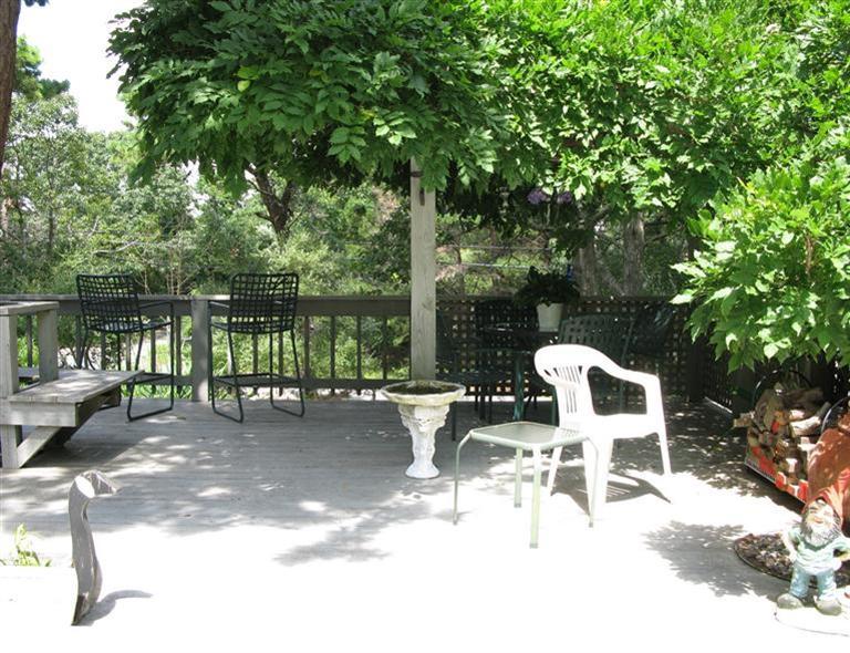 20 Massasoit Road Wellfleet, MA 02667 - Photo 25 of 35 a view of a patio with a table chairs and a lake view