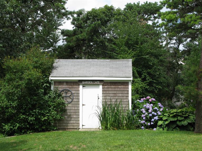 20 Massasoit Road Wellfleet, MA 02667 - Photo 32 of 35 a view of a house with a small yard and large trees