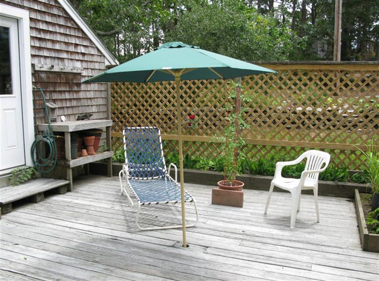 20 Massasoit Road Wellfleet, MA 02667 - Photo 33 of 35 a view of a patio with a table and chairs under an umbrella