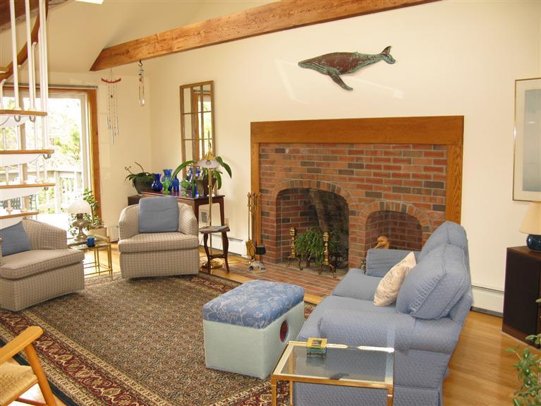 20 Massasoit Road Wellfleet, MA 02667 - Photo 4 of 35 a living room with furniture and a fireplace