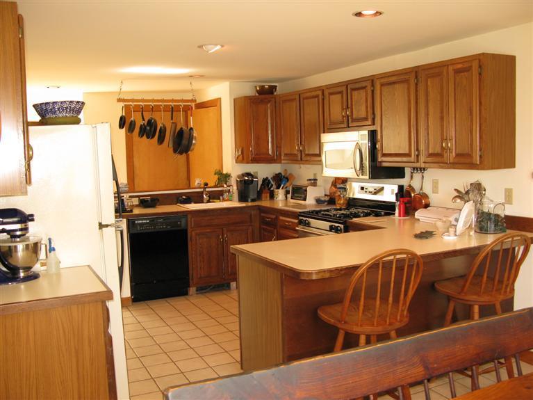 20 Massasoit Road Wellfleet, MA 02667 - Photo 7 of 35 a kitchen with stainless steel appliances granite countertop a sink stove and refrigerator