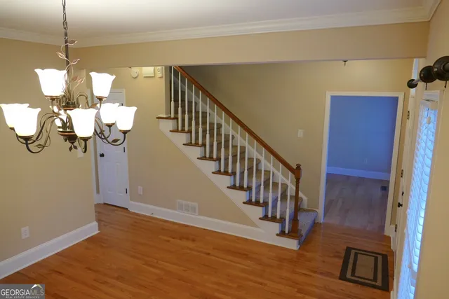 a view of entryway and hall with wooden floor