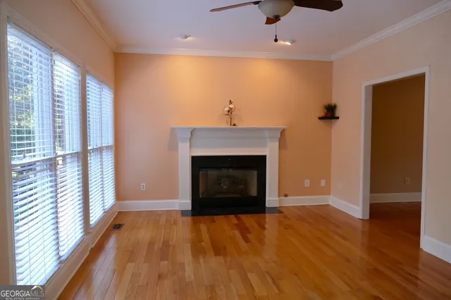 wooden floor fireplace and natural light in room
