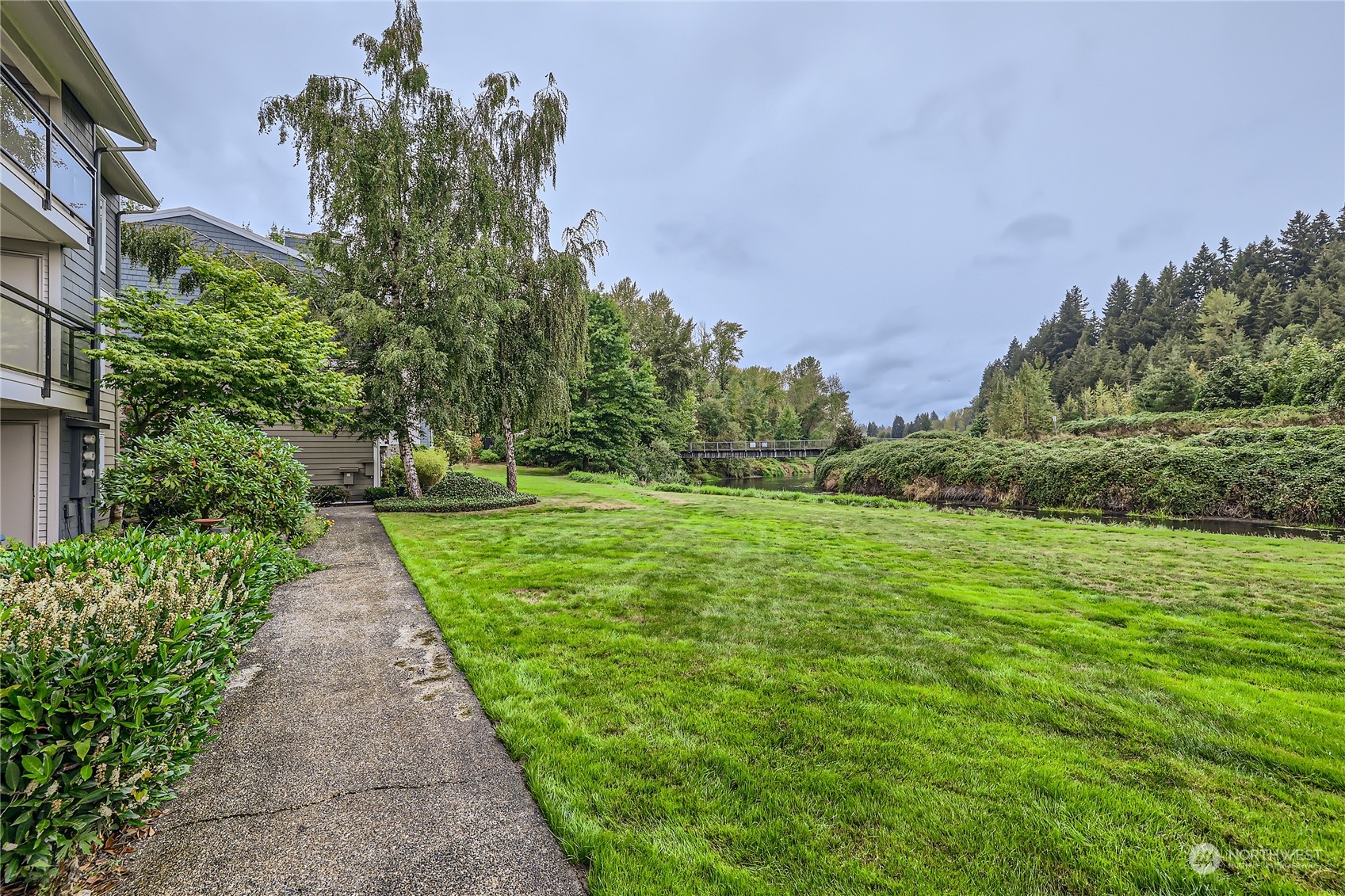 10830 East Riverside Drive, Unit B301 Bothell, WA 98011 - Photo 11 of 11 a view of a park with large trees
