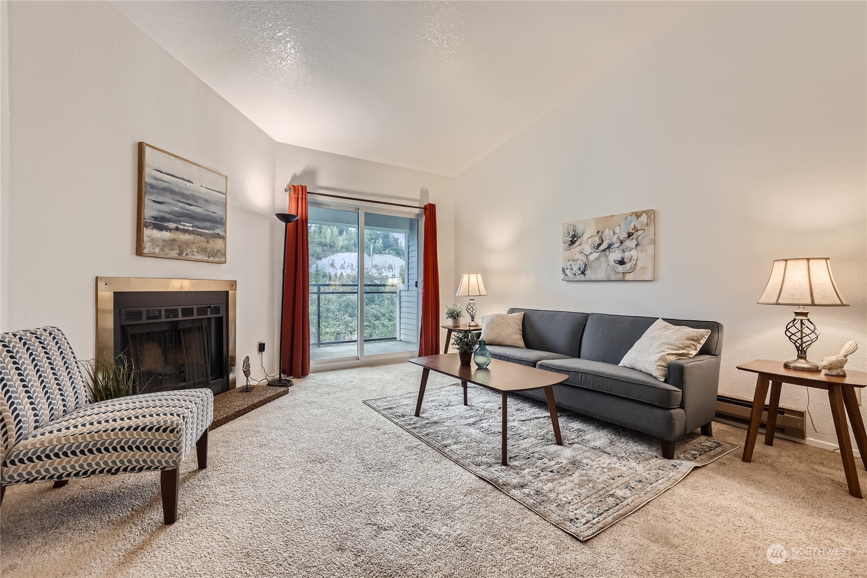 10830 East Riverside Drive, Unit B301 Bothell, WA 98011 - Photo 2 of 11 a living room with furniture and a fireplace