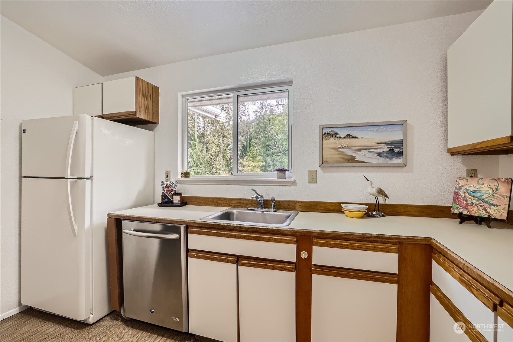 10830 East Riverside Drive, Unit B301 Bothell, WA 98011 - Photo 4 of 11 a kitchen with stainless steel appliances granite countertop a sink stove and refrigerator