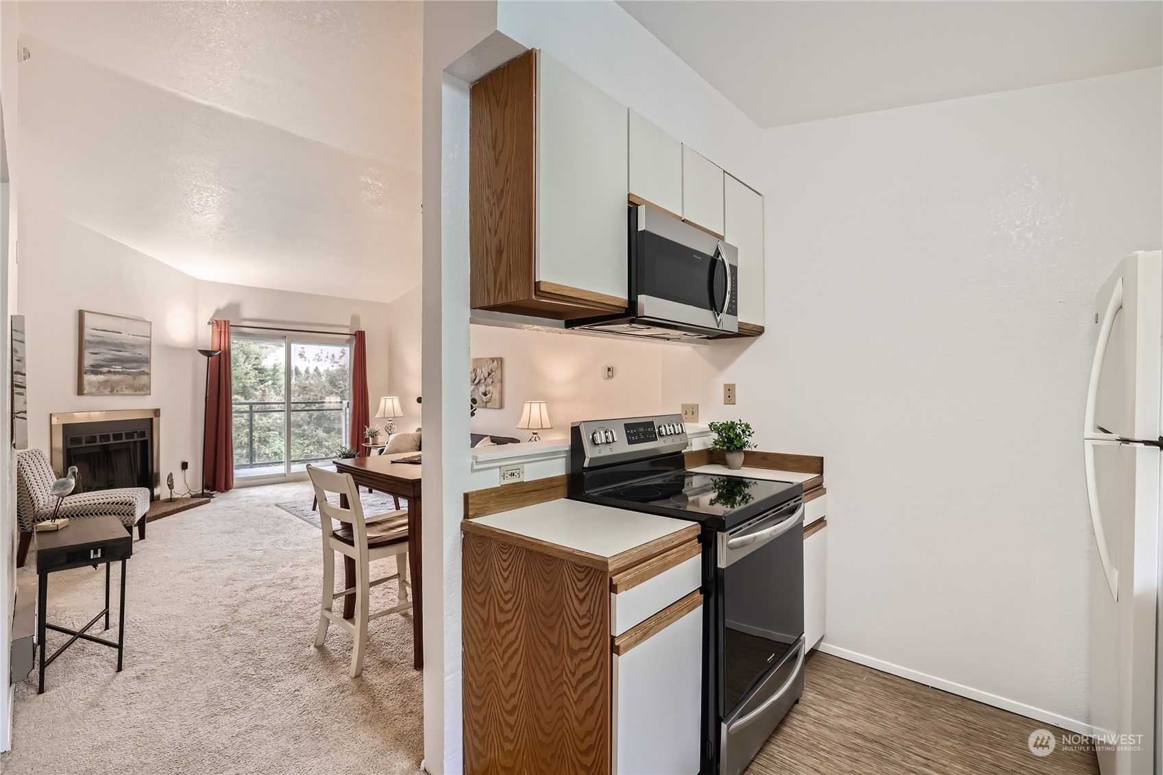 10830 East Riverside Drive, Unit B301 Bothell, WA 98011 - Photo 5 of 11 a view of kitchen with sink microwave and stove